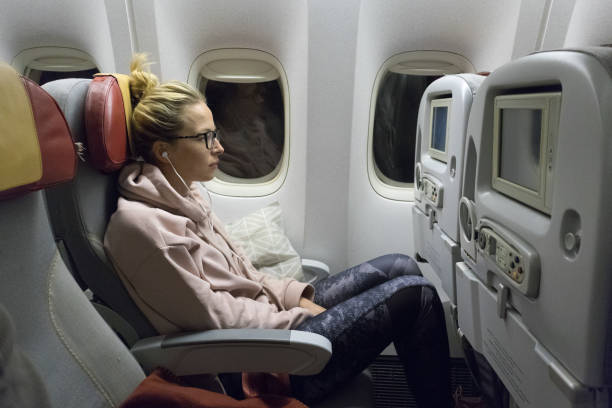 istock Side View Of Woman Sitting In Airplane 1281624713