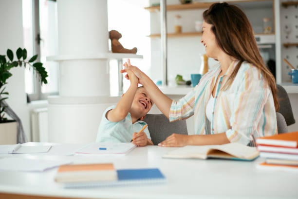 istock Mother helping her son with homework at home. 1281625374