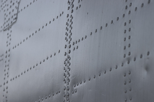 Aluminum surface of the aircraft fuselage. Iron panel of airplane.  Abstract metal background.