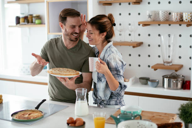 istock Young couple making pancakes at home. 1281626251