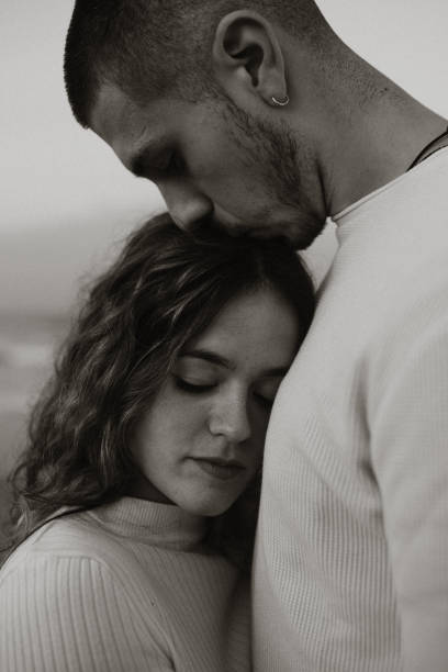 istock Young couple at the beach at sunset 1281627338