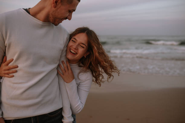 istock Young couple at the beach at sunset 1281627630