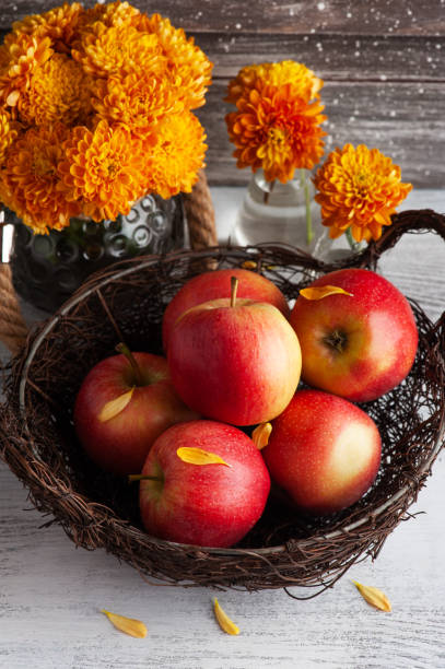 istock Ripe red apples and yellow chrysanthemum 1281627798