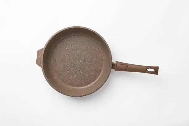 New frying pan on a white background, with non-stick coating