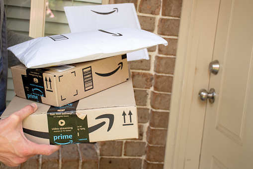 Sydney, Australia - 2020-10-17 Amazon prime boxes and envelopes delivered to a front door of residential building.