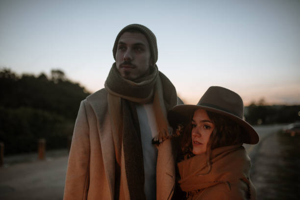 istock Young couple on a road at sunset 1281631990