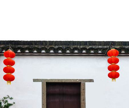 Chinese traditional architecture, two-story building with neat tiles on the roof and red lanterns hanging