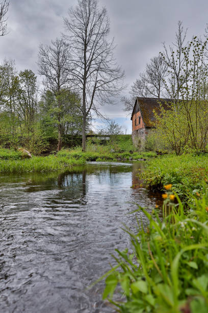istock Spring landscape view with old river near historic waterfall. 1281634802