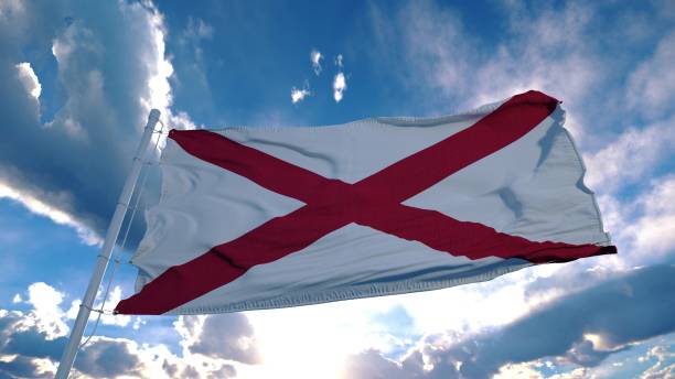 alabama flagge auf einem fahnenmast weht im wind am himmel. bundesstaat alabama in den vereinigten staaten von amerika. 3d-rendering - maryland flag banner us state flag stock-fotos und bilder