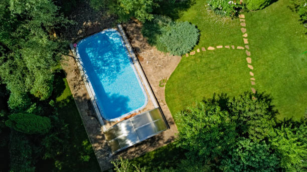 istock Swimming pool in beautiful garden aerial top view 1281636730