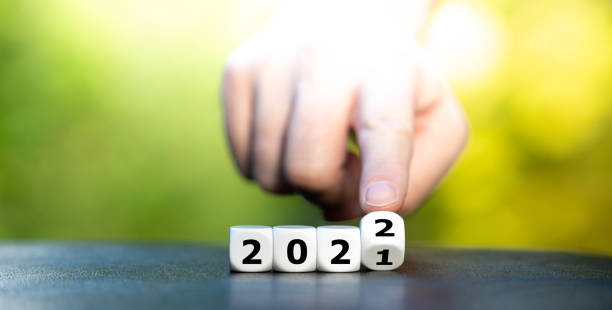 istock Hand turns dice and changes the year 2021 to 2022. 1281639188
