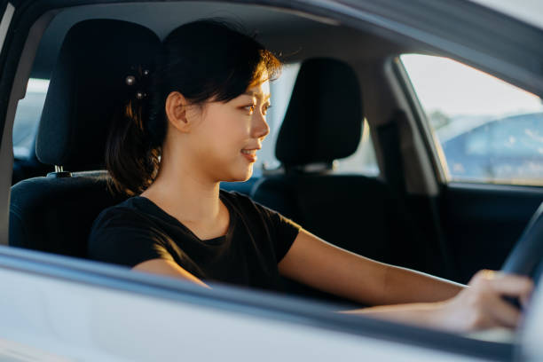 istock Young asian woman driving a car 1281640289