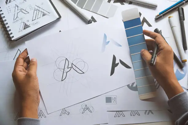 Photo of Graphic designer creative design sketch drawing logo Trademark brand Workspace