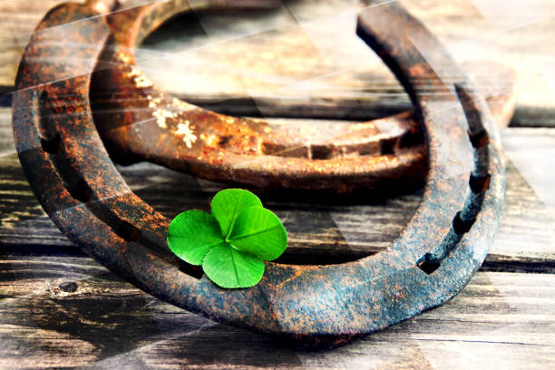 istock Horseshoe with lucky clover 4 leaves on wood 1281641620