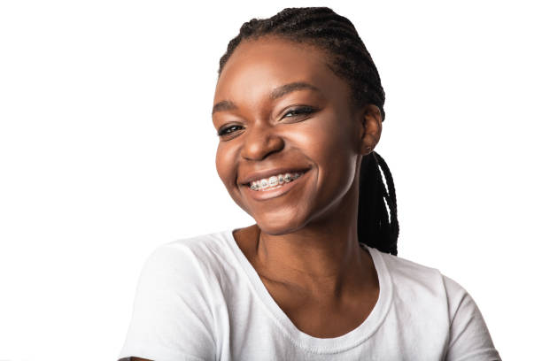 African Woman With Dental Braces Smiling Posing Over White Background Orthodontics Treatment. African American Woman With Dental Braces Smiling To Camera Posing Over White Background In Studio. Black Female Portrait, Orthodontic Brackets Advertisement Concept braces stock pictures, royalty-free photos & images