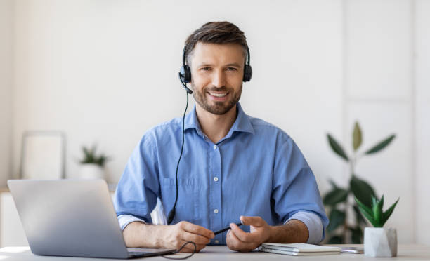 istock Portrait of smiling male customer service operator in headset at workplace 1281642245