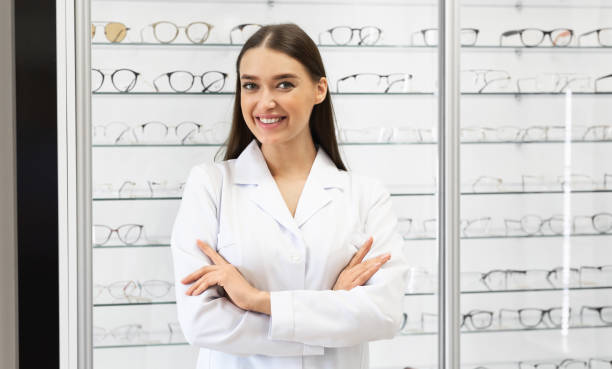 istock Happy female optometrist standing in optics store 1281642357