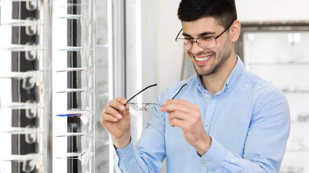 istock Portrait of handsome young customer choosing spectacles 1281642613