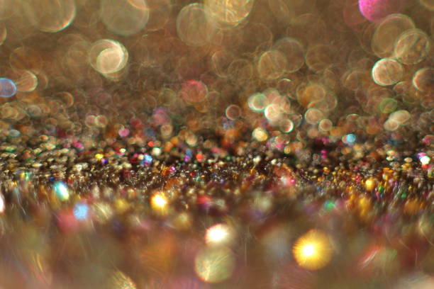 background of abstract glitter lights. gold, blue red, pink,and black. de focused