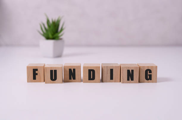 istock Funding Word Written In Wooden Cube on white. 1281644848