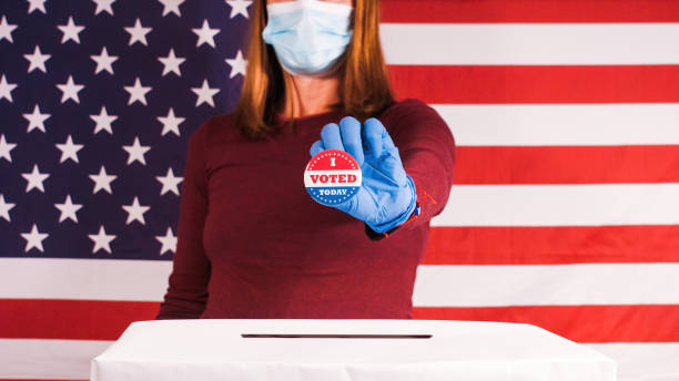 istock Woman with face mask voting 1281645999
