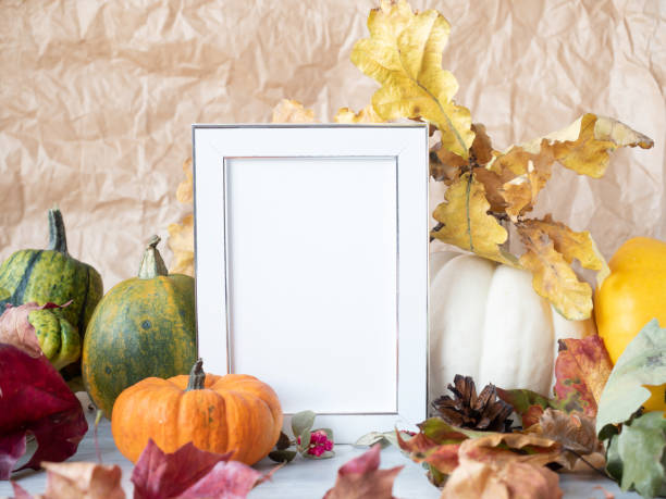 istock Empty photo frame on autumn background with decorative pumpkins 1281648998