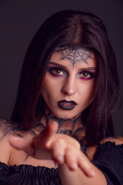istock halloween make up spider web close up shot in dark background 1281649174