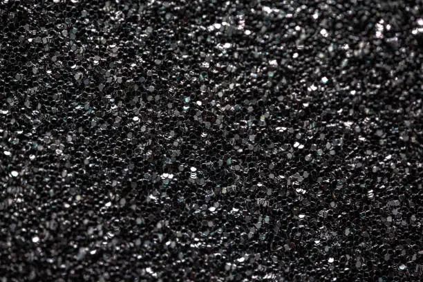 Black glitter texture background macrophotography. Perfectly usable for all elegance and luxury related projects.