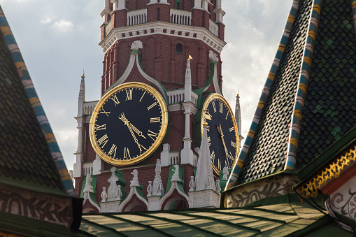 Kremlin Clock on the Spasskaya Tower of Kremlin palace against cloudy sky in Moscow,Russia