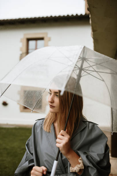 istock Young woman with an umbrella 1281652881