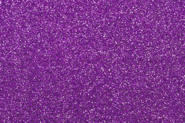 istock Purple sparkly fabric texture, Christmas paper backgrounds. Dark violet glitter surface. Abstract grain pattern. Festive decoration. Shiny sequins. Holiday art design with lights, shiny effect. 1281653843