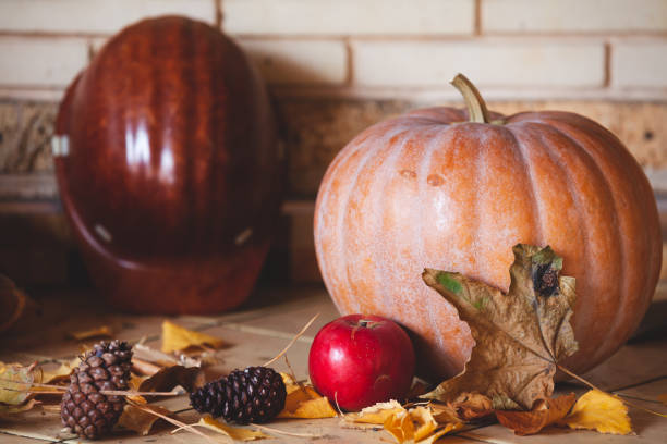 istock Round pumpkin and apple lie on shelf 1281653913