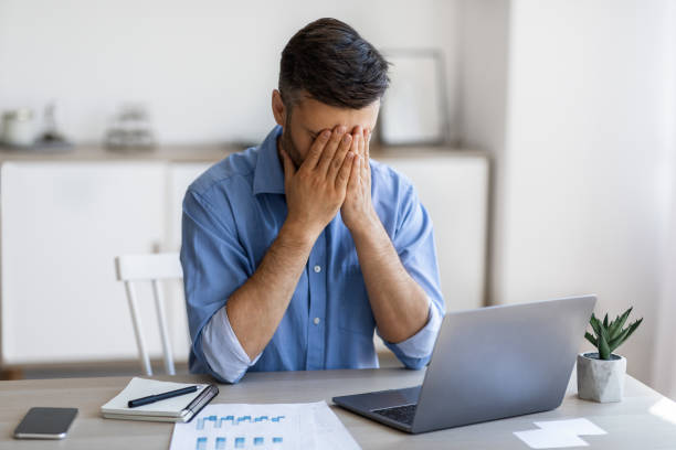 istock Fatigue From Work. Stressed male entrepreneur covering face with hands at workplace 1281654907
