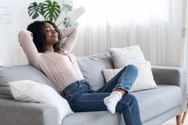 istock Weekend At Home. Relaxed African American Woman Leaning Back On Couch 1281655596