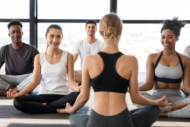 istock Group of multicultural man and woman practicing yoga with instructor in studio 1281655711