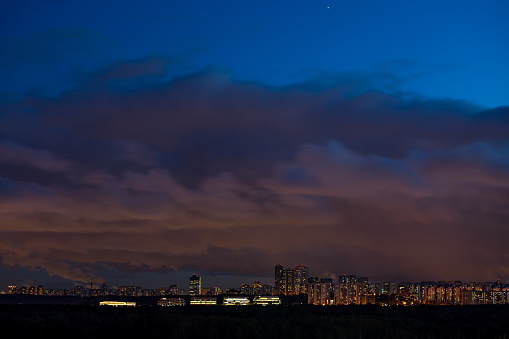 Night shot of city skyline and dramatic sky