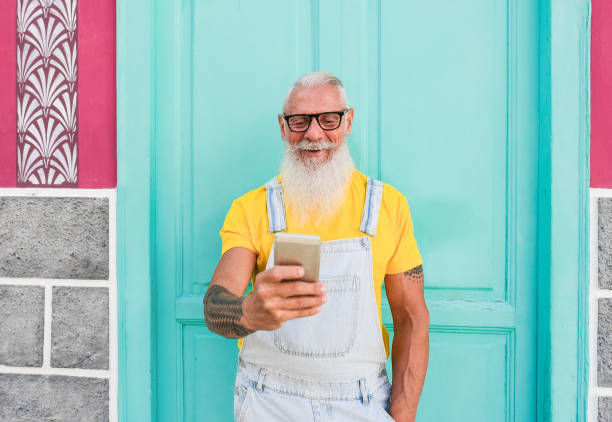istock Senior hipster man with mobile smartphone laughing - Elderly generation enjoy technology 1281656332