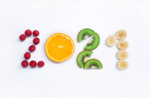 istock New year 2021 made of fruit and berries on white background, top view. 1281656372