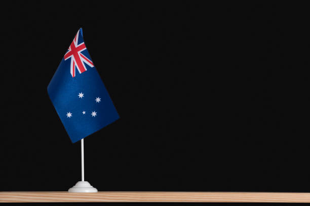 istock Flag pole. National table flag of Australia on black background. 1281656379