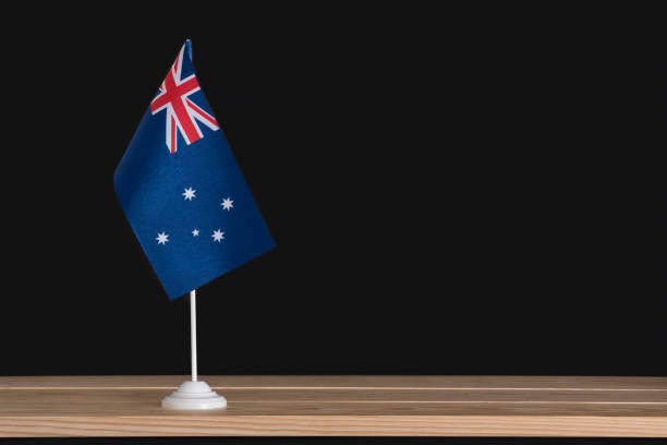 istock National table flag of Australia on black background. Flag pole. Copy space 1281656381