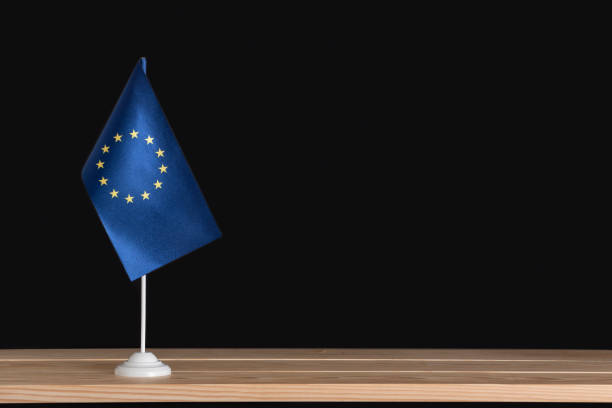 istock Flag pole. National table flag of EU on black background. 1281656638