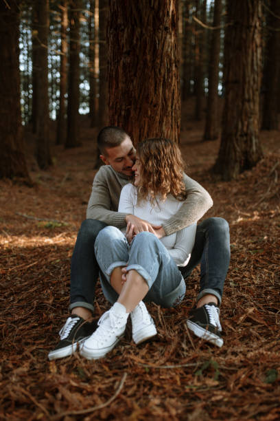 istock Young couple sitting in a forest 1281657713