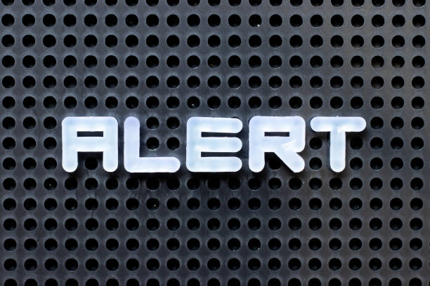istock White color alphabet with word alert on black pegboard background 1281658444