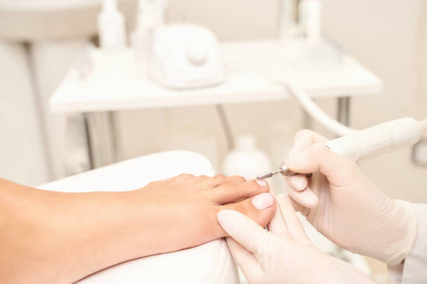istock Classic pink wedding toe nail manicure on white backdrop. Spa treatment concept 1281658685