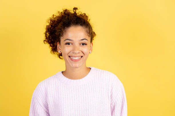istock Young afro american woman on yellow copy space background 1281659465