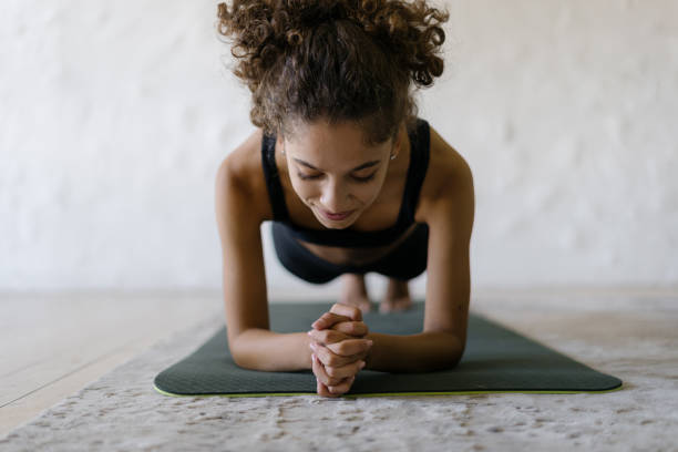 Young afro american sportswoman training at home