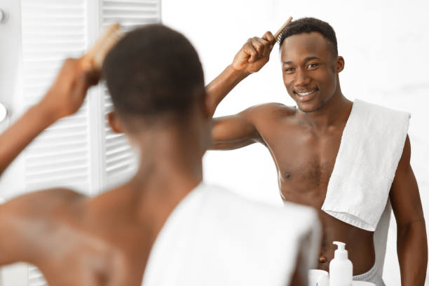 istock Black Guy Brushing And Combing Hair Using Hairbrush In Bathroom 1281660277