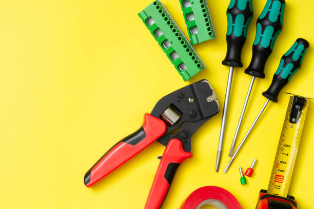 istock Tools of an electrician installer on a yellow background. Building tool 1281661422