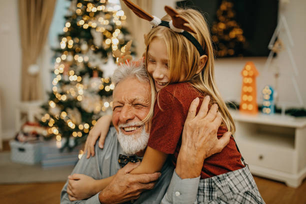 Grandfather and granddaughter preparing for New year Grandfather and granddaughter preparing for New year multi generation family christmas stock pictures, royalty-free photos & images