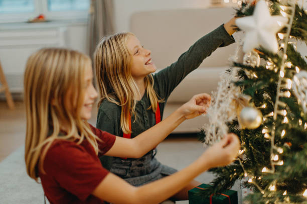 istock Twin girls decorating for Christmas 1281661929